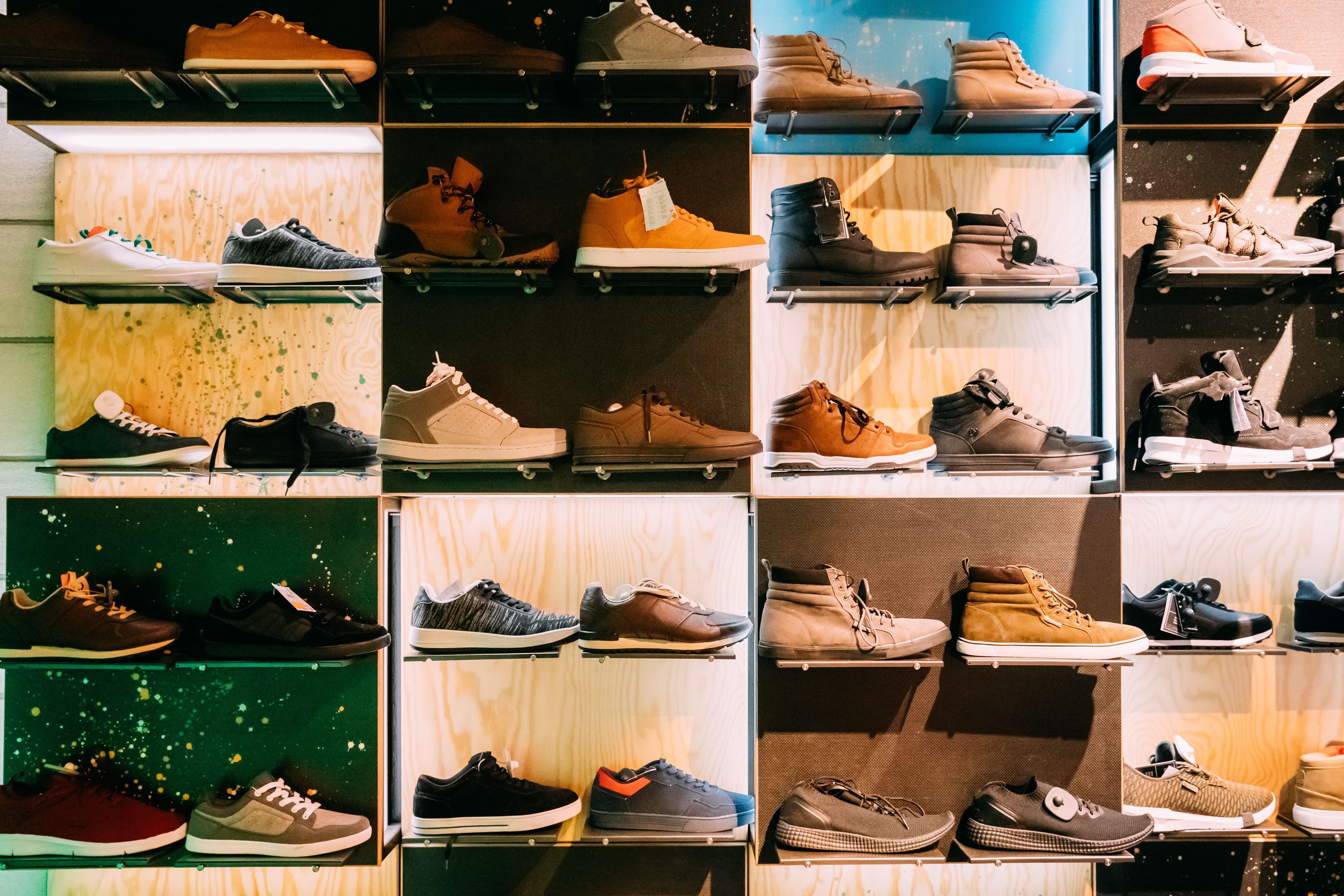 Various sneakers and boots displayed on shelves.